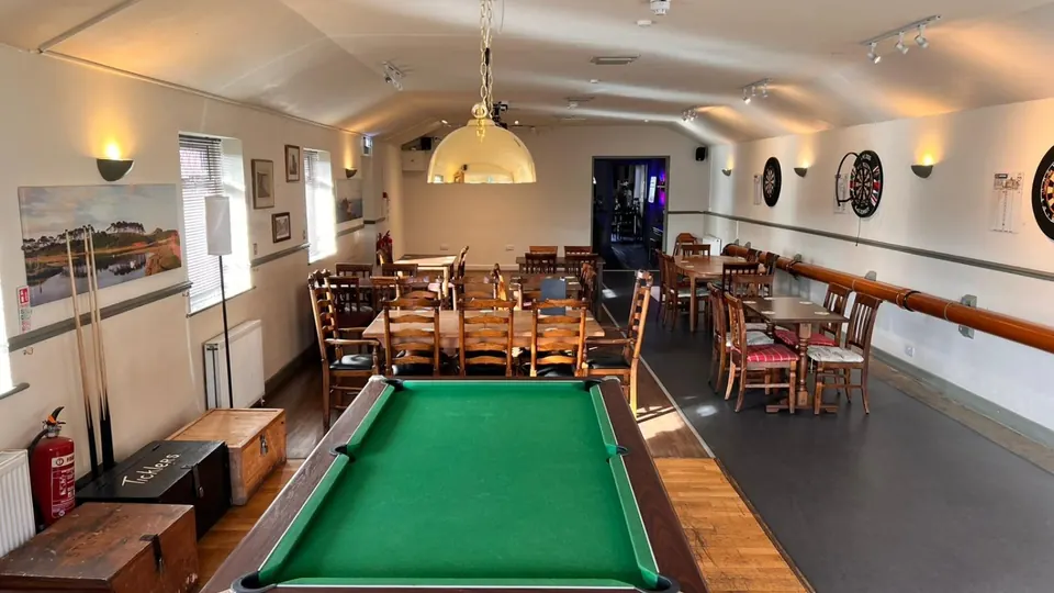 The function room with pool table and dartboards