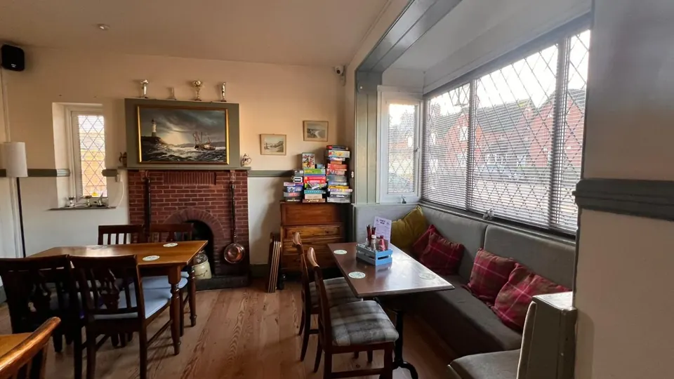 A cosy corner of the bar by the fireplace